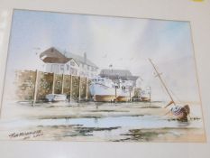 A framed watercolour of estuary scene by Tom McCra