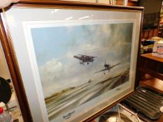 A large framed military aircraft print