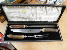 A boxed carving set with horn handles