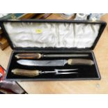 A boxed carving set with horn handles