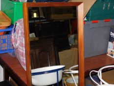 A teak framed mirror twinned with one other