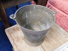An antique brass bucket