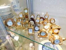 A selection of twenty three brass miniature clocks