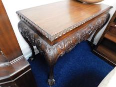 A large 20thC. reproduction mahogany hall table with piecrust edge, carved decor & ball & claw feet