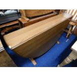 A D shaped Ercol elm drop leaf table with golden d