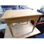 A small stripped pine farmhouse table