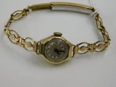 A ladies wristwatch with yellow metal case & strap