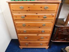 A tall pine chest comprising six drawers