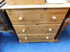 A low level three drawer pine chest