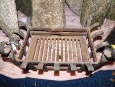 An antique iron fire basket