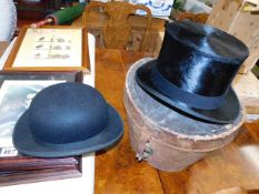 A Cuthbertson top hat with leather hat case twinne