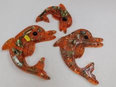 Three resin dolphin wall plaques & one seahorse