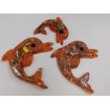 Three resin dolphin wall plaques & one seahorse