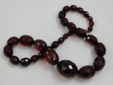 A set of faceted red amber style beads