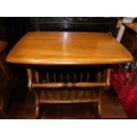 An Ercol elm magazine rack table with golden dawn