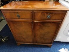 A sideboard with cupboard & two drawers