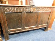 An 18thC. oak coffer with carved frieze