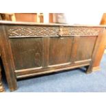 An 18thC. oak coffer with carved frieze