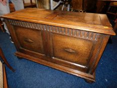 A 20thC. oak blanket box with bun feet