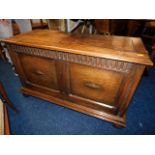 A 20thC. oak blanket box with bun feet