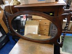 An oak framed mirror with barley twist decor