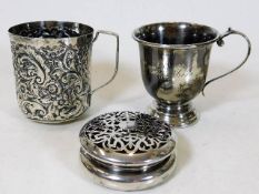 An embossed white metal cup, a silver christening