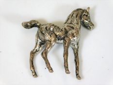 A small silver horse ornament