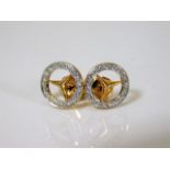 A pair of Mercedes Benz earrings set with diamonds
