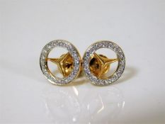 A pair of Mercedes Benz earrings set with diamonds