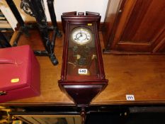 A 20thC. wall clock with pendulum & gong
