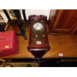 A 20thC. wall clock with pendulum & gong