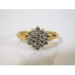 An 18ct gold diamond cluster ring with approx half