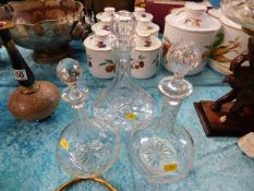 A cut glass ships decanters & two other decanters
