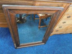 A large early 20thC. mirror with stained pine fram