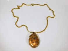A 9ct gold chain set with earlier metal locket dec