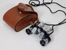 A cased set of AOG miniature binoculars