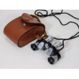 A cased set of AOG miniature binoculars