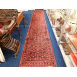 A Persian hall carpet runner measuring 198in x 34i