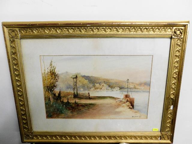 A framed watercolour depicting estuary scene signe