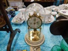 An anniversary style clock with glass dome