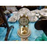 An anniversary style clock with glass dome