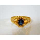 A Chinese high carat gold ring set with a sapphire