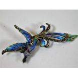 A white metal bird of paradise brooch with enamell