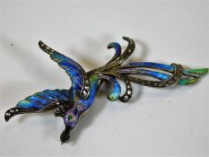 A white metal bird of paradise brooch with enamell