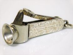 An antique silver cigar cutter with chased decor t