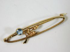A yellow metal brooch set with seed pearl & topaz