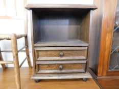 A small oak bedside table with two drawers