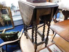 An oak drop leaf table with barley twist legs