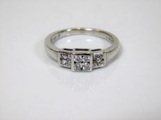 An 18ct gold art deco style ring set with 12 diamo