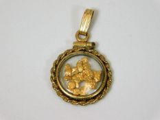 A yellow metal pendant with pure gold nuggets 1.7g